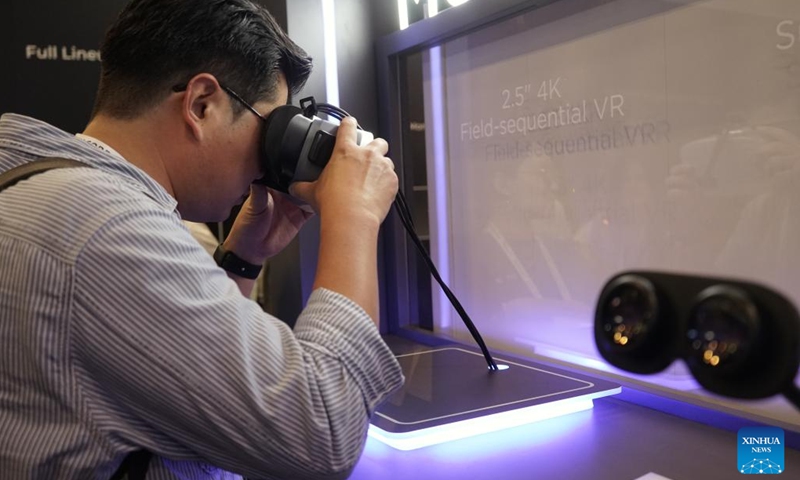 A man visits the exhibition area of China's BOE Technology Group during the Display Week 2023 in Los Angeles, the United States, on May 23, 2023. Chinese brands gained a strong foothold at the Display Week 2023, a world's leading show of the display industry held this week in Los Angeles, attracting lots of attention and winning recognition for their innovative technologies and products.(Photo: Xinhua)