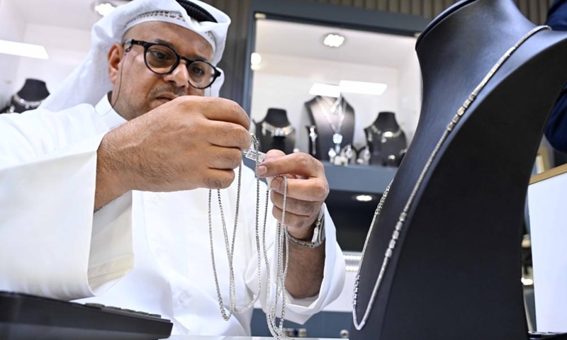 A seller displays jewelry at the 19th International Gold and Jewelry Exhibition in Hawalli Governorate, Kuwait, on May 24, 2023. The 19th International Gold and Jewelry Exhibition kicked off here on Wednesday, with the participation of more than 190 local and international companies.(Photo: Xinhua)