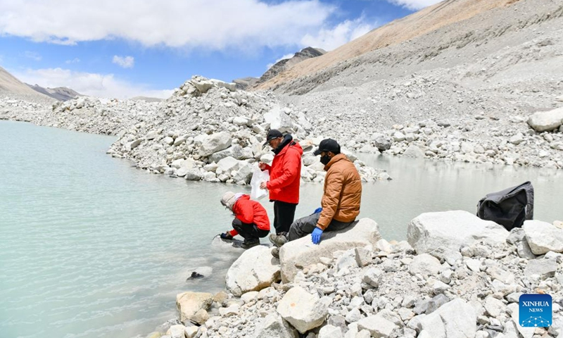Scientific research members with the Institute of Tibetan Plateau Research under the Chinese Academy of Sciences (CAS) check the water quality of a proglacial lake in the Mount Qomolangma region at an altitude of 5,300 meters, in southwest China's Tibet Autonomous Region, on May 12, 2023. The 2023 Mt. Qomolangma expedition is part of the second comprehensive scientific expedition on the Qinghai-Tibet Plateau, initiated in 2017.(Photo: Xinhua)