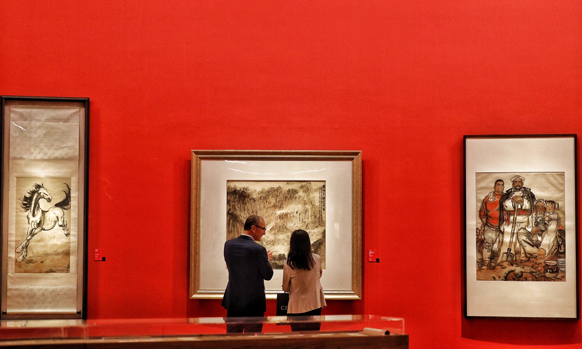 Visitors explore an exhibition to mark the 60th anniversary of the National Art Museum of China. Photo: Li Hao/Global Times