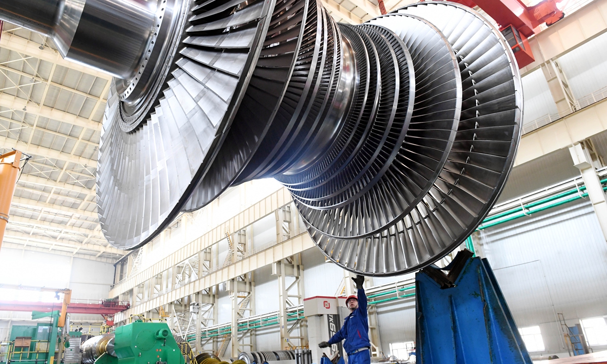 Workers hoist a giant component of a turbine at a plant of Harbin Turbine Co in Harbin, Northeast China's Heilongjiang Province on May 23, 2023. China's equipment manufacturing sector saw rapid expansion in April with a year-on-year growth rate of 13.2 percent. Photo: VCG