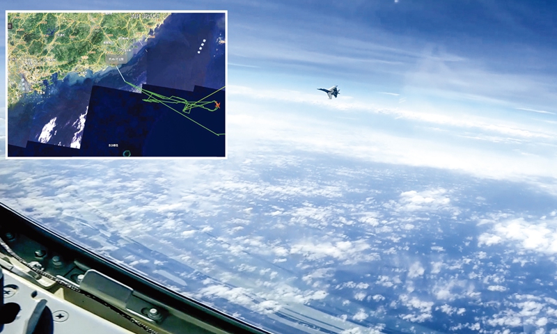 Picture shows Chinese J-16 fighter jet flies over the South China Sea on May 26, 2023. US RC-135 spy plane made an intrusion into PLA Navy Shandong aircraft carrier group's training zone in the South China Sea on May 26, 2023, and PLA Southern Theater Command organized aerial forces to monitor, track and professionally dealt with the situation in accordance with law and regulation. Inset: Picture illustrating the flight paths of the US RC-135 electronic reconnaissance aircraft. Photo: VCG