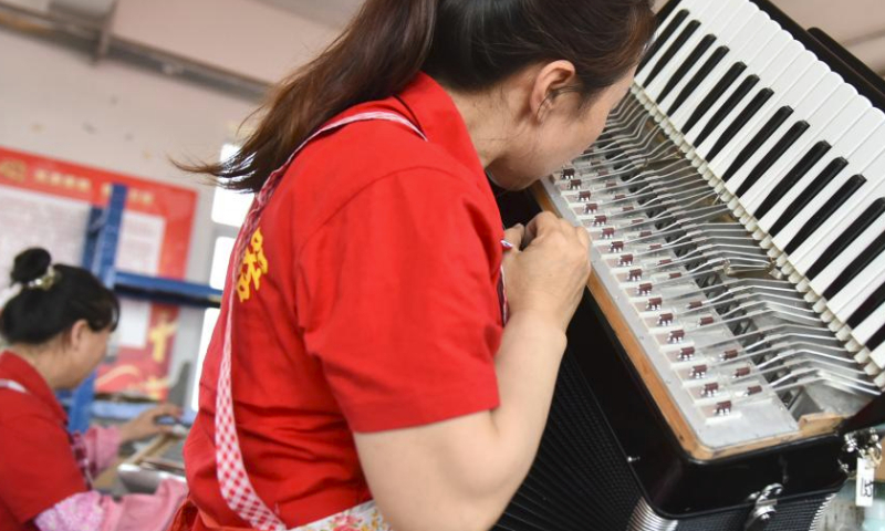 Workers assemble accordions at a workshop of Tianjin Yingwu Musical Instrument Co., Ltd. in Zhongwang Town of Jinghai District, north China's Tianjin, May 25, 2023.

Tianjin Yingwu Musical Instrument Co., Ltd. is an enterprise with 71 years of accordion manufacturing history. In the 1950s, its predecessor Tianjin Musical Instrument Factory produced the first accordion in new China, with a brand named Yingwu. From then on, the Yingwu accordions produced here became famous at home and abroad.

In recent years, the enterprise has been carrying out technological innovation and product research and development, and promoting cooperation with foreign brands. At present, the upgraded and optimized Yingwu branded accordions of the enterprise has entered the market, and the time-honored brand continues to glow with new vitality. (Xinhua/Li Mangmang)
