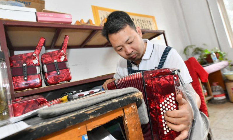 A worker tunes an accordion at Tianjin Yingwu Musical Instrument Co., Ltd. in Zhongwang Town of Jinghai District, north China's Tianjin, May 25, 2023.

Tianjin Yingwu Musical Instrument Co., Ltd. is an enterprise with 71 years of accordion manufacturing history. In the 1950s, its predecessor Tianjin Musical Instrument Factory produced the first accordion in new China, with a brand named Yingwu. From then on, the Yingwu accordions produced here became famous at home and abroad.

In recent years, the enterprise has been carrying out technological innovation and product research and development, and promoting cooperation with foreign brands. At present, the upgraded and optimized Yingwu branded accordions of the enterprise has entered the market, and the time-honored brand continues to glow with new vitality. (Xinhua/Sun Fanyue)