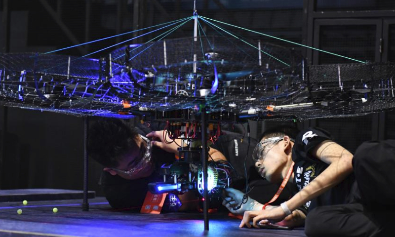 Contestants of team TOE from Dalian Jiaotong University test their robots during the RoboMaster 2023 University Championship Regional Competition (South China) in Changsha, central China's Hunan Province, May 28, 2023. The four-day regional competition concluded in Changsha on Sunday, with team RobotPilots from Shenzhen University winning the first place and team TOE from Dalian Jiaotong University being the second. (Xinhua/Chen Zhenhai)