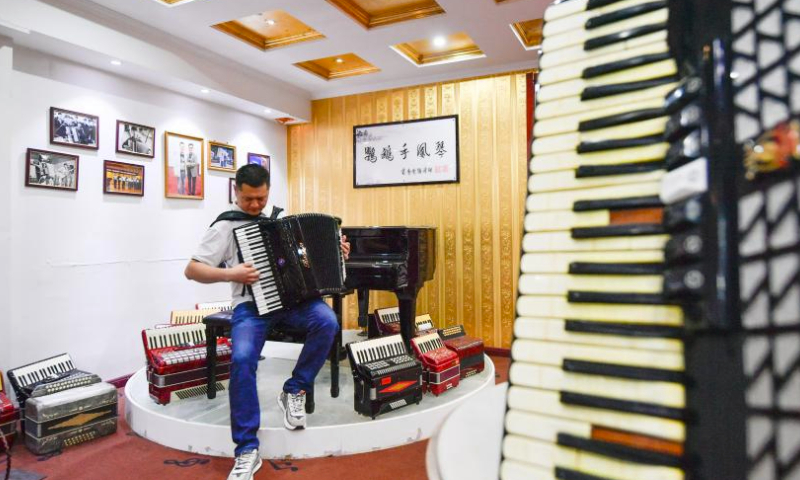 A worker plays music with an accordion at Tianjin Yingwu Musical Instrument Co., Ltd. in Zhongwang Town of Jinghai District, north China's Tianjin, May 25, 2023.

Tianjin Yingwu Musical Instrument Co., Ltd. is an enterprise with 71 years of accordion manufacturing history. In the 1950s, its predecessor Tianjin Musical Instrument Factory produced the first accordion in new China, with a brand named Yingwu. From then on, the Yingwu accordions produced here became famous at home and abroad.

In recent years, the enterprise has been carrying out technological innovation and product research and development, and promoting cooperation with foreign brands. At present, the upgraded and optimized Yingwu branded accordions of the enterprise has entered the market, and the time-honored brand continues to glow with new vitality. (Xinhua/Sun Fanyue)