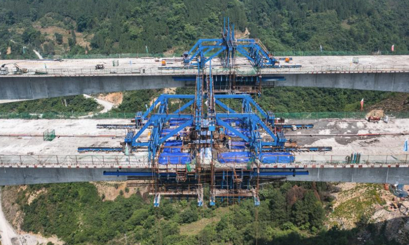 This aerial photo taken on May 27, 2023 shows the construction site of Qingchi grand bridge in Jinsha County of Bijie City, southwest China's Guizhou Province. The bridge is a key project along the Guiyang-Jinsha-Gulin expressway. The construction of the bridge has been proceeding smoothly. (Xinhua/Tao Liang)