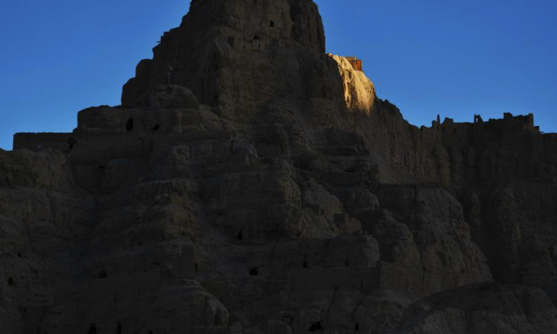 This photo taken on May 26, 2023 shows the sunset glow illuminating the ruins of the Guge Kingdom at dusk in Zanda County of Ngari Prefecture, southwest China's Tibet Autonomous Region. The ancient Guge Kingdom was probably founded in the 10th century but it was abandoned by the end of the 17th century. Only the mud-and-rock structures remained, sheltering their relics and wall paintings from the elements.

The Guge Kingdom Ruins are among the first group of historical relics placed under state protection in China. Remains of the kingdom's main castle now lie atop a riverside mountain, covering 180,000 square meters. (Xinhua/Fei Maohua)