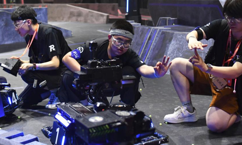 Contestants of team TOE from Dalian Jiaotong University test their robots during the RoboMaster 2023 University Championship Regional Competition (South China) in Changsha, central China's Hunan Province, May 28, 2023. The four-day regional competition concluded in Changsha on Sunday, with team RobotPilots from Shenzhen University winning the first place and team TOE from Dalian Jiaotong University being the second. (Xinhua/Chen Zhenhai)