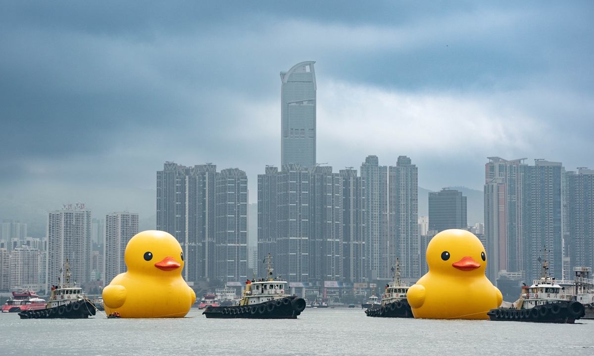 A pair of 18-meter-tall giant rubber ducks created by Dutch artist Florentijn Hofman return to Hong Kong on May 25, 2023, a decade after they first 