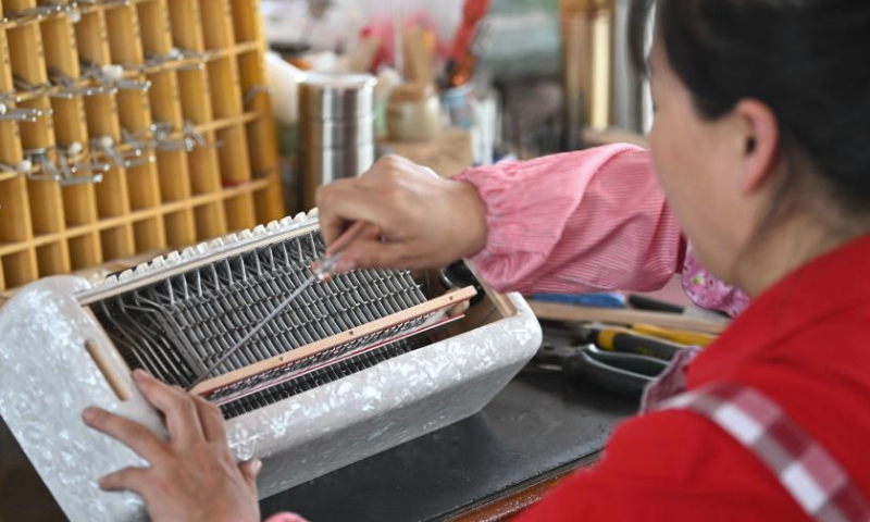 A worker assembles an accordion at a workshop of Tianjin Yingwu Musical Instrument Co., Ltd. in Zhongwang Town of Jinghai District, north China's Tianjin, May 25, 2023.

Tianjin Yingwu Musical Instrument Co., Ltd. is an enterprise with 71 years of accordion manufacturing history. In the 1950s, its predecessor Tianjin Musical Instrument Factory produced the first accordion in new China, with a brand named Yingwu. From then on, the Yingwu accordions produced here became famous at home and abroad.

In recent years, the enterprise has been carrying out technological innovation and product research and development, and promoting cooperation with foreign brands. At present, the upgraded and optimized Yingwu branded accordions of the enterprise has entered the market, and the time-honored brand continues to glow with new vitality. (Xinhua/Sun Fanyue)
