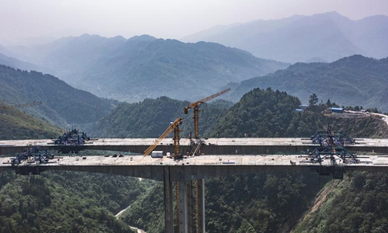 This aerial photo taken on May 27, 2023 shows the construction site of Qingchi grand bridge in Jinsha County of Bijie City, southwest China's Guizhou Province. The bridge is a key project along the Guiyang-Jinsha-Gulin expressway. The construction of the bridge has been proceeding smoothly. (Xinhua/Tao Liang)