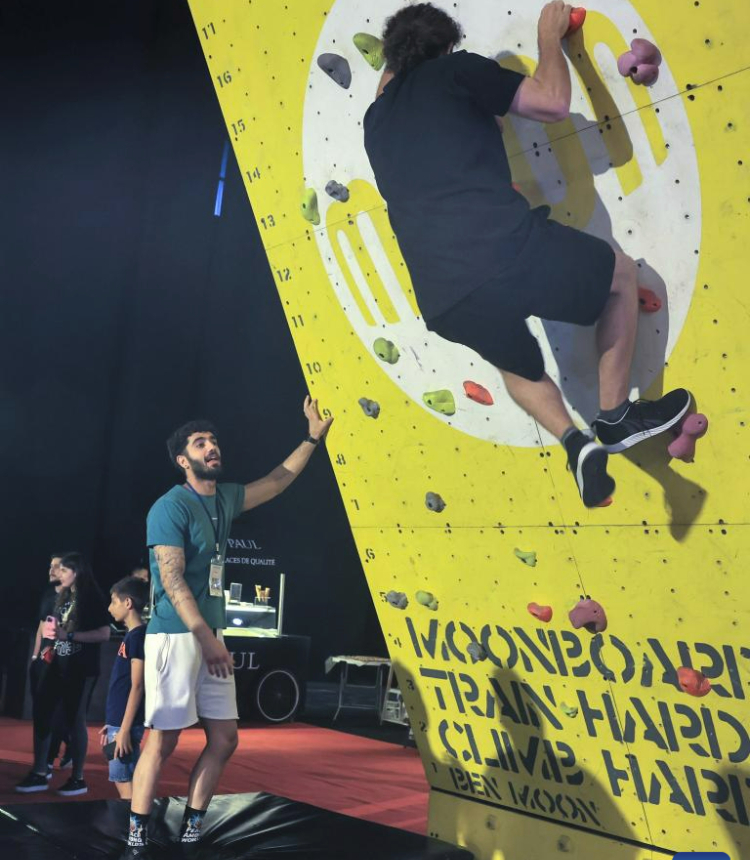 A participant tries sport climbing during a Beirut Sports Festival held in Beirut, Lebanon, May 27, 2023. (Xinhua/Liu Zongya)