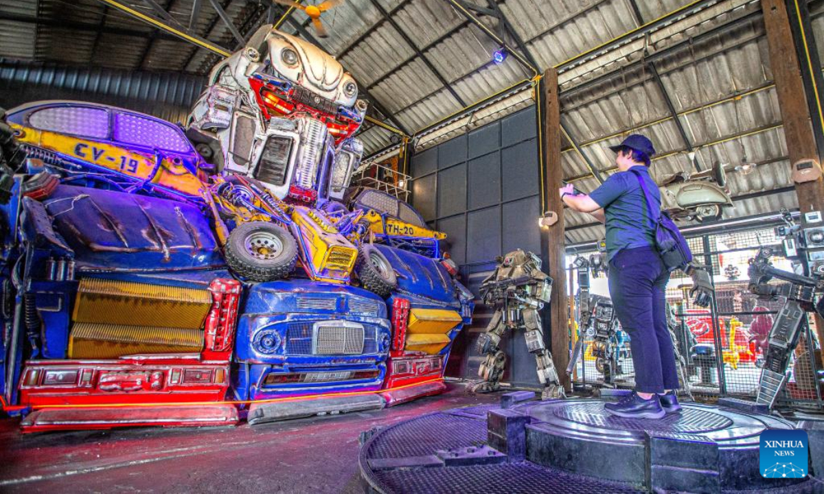 A tourist takes photos at the Transformer Museum in Ang Thong, Thailand, May 25, 2023. The Transformer Museum displays robots and other artworks made from scrap metal, aming to convey the concept of environmental protection. Photo:Xinhua