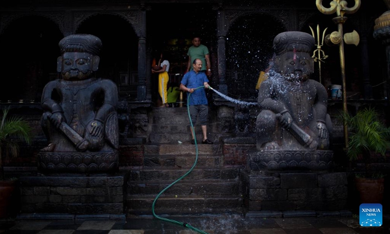 A man cleans a statue on the occasion of Sithi Nakha Festival in Bhaktapur, Nepal, May 25, 2023. The Newar community celebrates the Sithi Nakha festival to mark the beginning of monsoon season by cleaning water sources such as ponds, wells and stone spouts.(Photo: Xinhua)