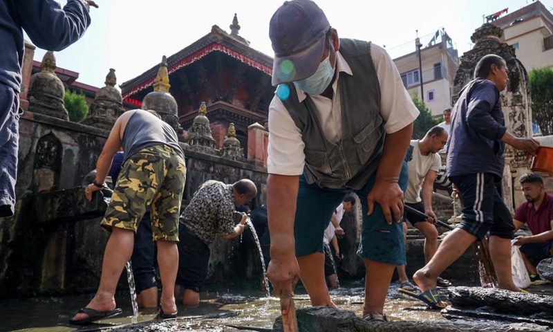 People clean stone water spouts on the occasion of Sithi Nakha Festival in Lalitpur, Nepal, May 25, 2023. The Newar community celebrates the Sithi Nakha festival to mark the beginning of monsoon season by cleaning water sources such as ponds, wells and stone spouts.(Photo: Xinhua)