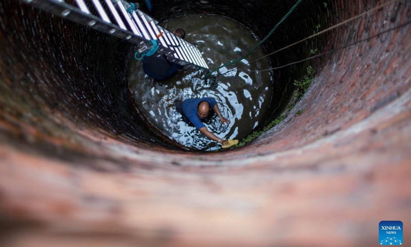 People clean a well on the occasion of Sithi Nakha Festival in Bhaktapur, Nepal, May 25, 2023. The Newar community celebrates the Sithi Nakha festival to mark the beginning of monsoon season by cleaning water sources such as ponds, wells and stone spouts. (Photo: Xinhua)