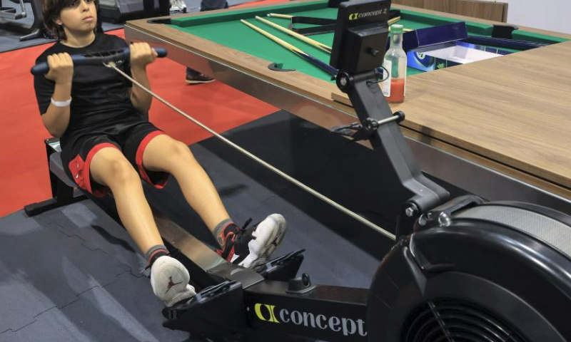 A participant tries a rowing machine during a Beirut Sports Festival held in Beirut, Lebanon, May 27, 2023. (Xinhua/Liu Zongya)