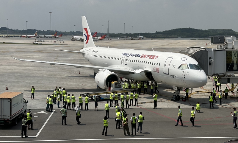 Workers inspect the C919 after landing at the Shanghai Hongqiao International Airport on May 29, 2023. Photo: Courtesy of Chen Zhencong 