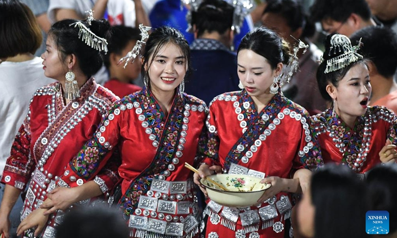 Villagers wearing festive ethnic dress are seen during the Village Super League football match in Rongjiang County of southwest China's Guizhou Province, June 17, 2023. Villagers spontaneously wear ethnic dress and perform singing and dancing on every match day on weekends. (Xinhua/Yang Wenbin)