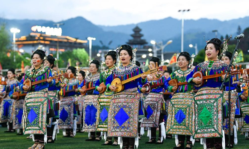 Villagers of Dong ethnic group wearing festive ethnic dress perform singing during the halftime of the Village Super League football match in Rongjiang County of southwest China's Guizhou Province, June 17, 2023. Villagers spontaneously wear ethnic dress and perform singing and dancing on every match day on weekends. (Xinhua/Yang Wenbin)