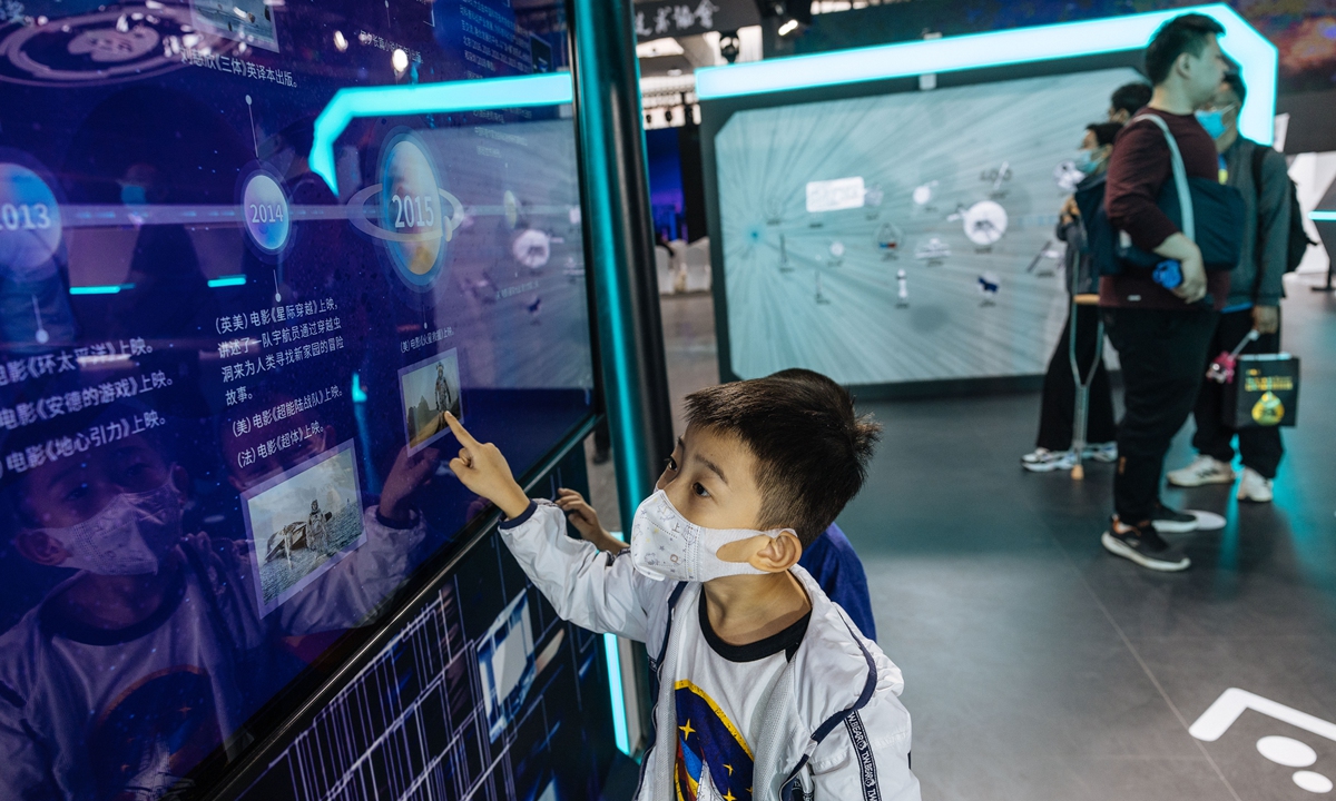 A boy goes through the exhibits at China Science Fiction Convention 2023 in Beijing on May 30, 2023. A range of latest technologies and products are showcased at the exhibition. Photo: Li Hao/GT