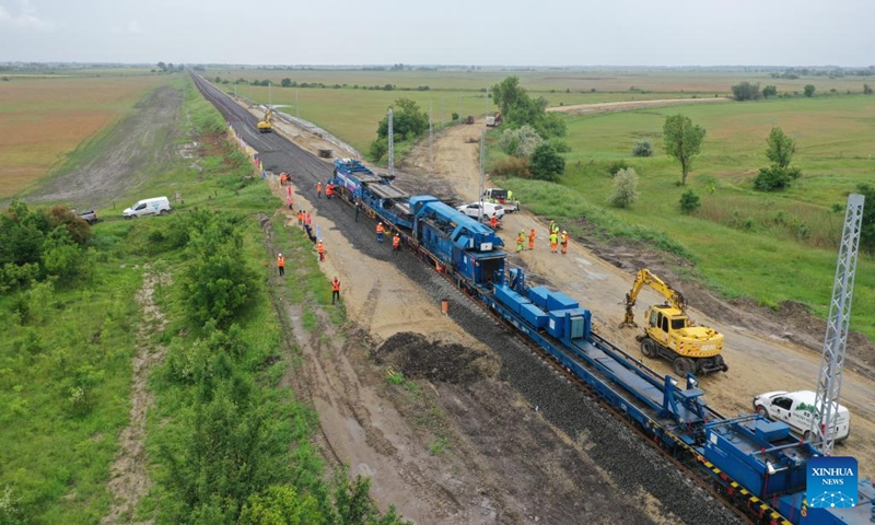 Photo taken on May 30, 2023 shows the track laying at the construction site of the Budapest-Belgrade railway in Kunszentmiklos, Hungary. Against the backdrop of dark skies, pouring rain, thunder, and lightning, the arduous task of laying rails for the Chinese-built section in Hungary of the Budapest-Belgrade railway project got underway here on Tuesday, marking a significant milestone in the project.(Photo: Xinhua)