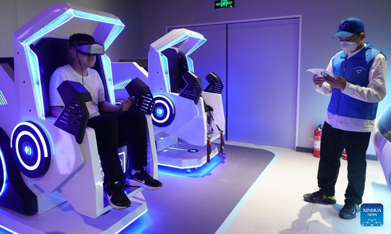 A visitor tries a VR equipment at an exhibition at China Science Fiction Convention (CSFC) 2023 in Beijing, capital of China, May 30, 2023. China Science Fiction Convention (CSFC) 2023 is scheduled to run in Beijing from May 29 to June 4. It is included as a sideline event of this year's Zhongguancun Forum (ZGC Forum) for the first time. Various events such as forums and sci-fi exhibitions are arranged in this year's convention.(Photo: Xinhua)