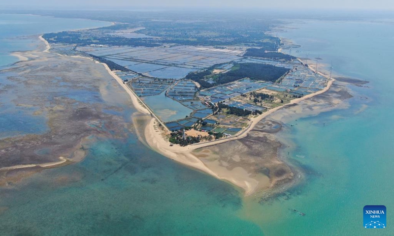 This aerial photo taken on May 27, 2023 shows the view of Deng Lou Corner in Nanji Village of Jiaowei Township of Xuwen County, Zhanjiang City, south China's Guangdong Province. The village, which is surrounded by Qiongzhou Strait and Beibu Gulf, is located in Jiaowei Township of Xuwen County. In recent years, more and more tourists are attracted to visit here for its good natural environment and unique fishing village atmosphere.(Photo: Xinhua)