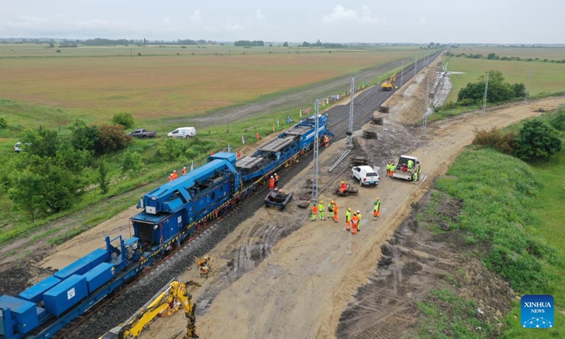 Photo taken on May 30, 2023 shows the track laying at the construction site of the Budapest-Belgrade railway in Kunszentmiklos, Hungary. Against the backdrop of dark skies, pouring rain, thunder, and lightning, the arduous task of laying rails for the Chinese-built section in Hungary of the Budapest-Belgrade railway project got underway here on Tuesday, marking a significant milestone in the project.(Photo: Xinhua)