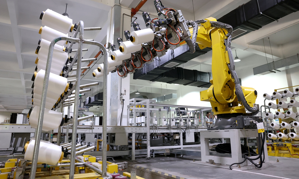 A robot catches up with orders on a textile production line in Fuzhou, capital of East China's Fujian Province on May 31, 2023. In the first four months of the year, China's investment in the high-tech manufacturing sector grew by 15.3 percent year-on-year, 8.9 percentage points higher than overall manufacturing. Photo: cnsphoto
