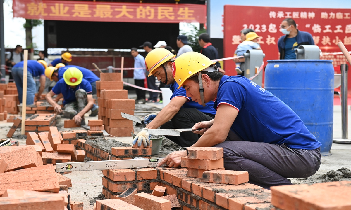 Masonry workers compete to show their skills in wall construction at a contemporary work distribution center in Hefei, East China's Anhui Province on May 31, 2023. A skill competition was held locally on the day. Photo:VCG