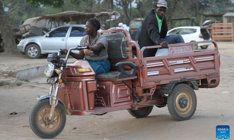 A woman provides taxi service to a man with an e-tricycle in Wedza, about 140 kilometres from Zimbabwe's capital Harare, May 19, 2023.(Photo: Xinhua)