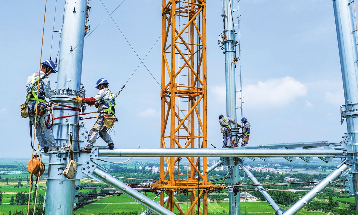 Workers of a power transmission company based in East China's Anhui Province install UHV transmission steel pipe towers in Nanchang, East China's Jiangxi Province on June 1, 2023. Power suppliers are ramping up to deal with an energy consumption peak that has come ahead of schedule amid a tight balance of supply, driven by hot weather in many areas. Photo: cnsphoto