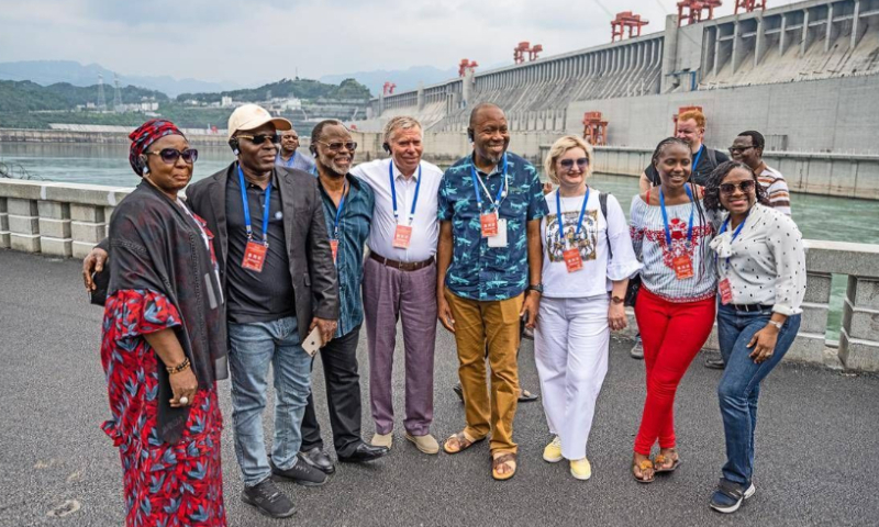 Austin Maho (2nd left), editor-in-chief of Nigeria's Daybreak News, stands with other foreign guests in front of the Three Gorges Dam in the city of Yichang in Central China's Hubei Province on May 31, 2023. Photo: Liu Shusong/Hubei Daily