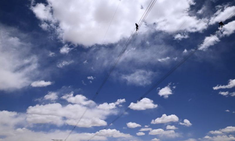Workers conduct routing inspection of power transmission lines at Tanggulashan Township of Golmud City in the Mongolian-Tibetan Autonomous Prefecture of Haixi, northwest China's Qinghai Province, June 3, 2023. Since 2012, the State Grid's Qinghai Electricity Power Company would conduct its annual centralized maintenance of the Qinghai-Tibet grid interconnection project, whose grid lines are laid at the plateau with an average altitude of 4,500 meters. Low temperatures, lack of oxygen and strong winds on the plateau challenge the operation and maintenance of the grid.

Over 420 workers would finish this year's maintenance work of 608-kilometer-long power transmission lines as well as the Qaidam Converter Station in 15 days recently.

Over 10.5 billion kWh of electricity has been transferred to Tibet through the Qinghai-Tibet grid interconnection project, which was put into operation in 2011. (Xinhua/Zhang Hongxiang)