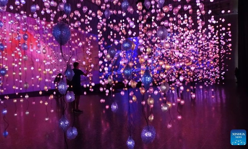 A visitor takes pictures inside Pixel Forest, an immersive presentation by Swiss artist Pipilotti Rist, at the Museum of Fine Arts, Houston, Texas, the United States, on May 31, 2023. The exhibition Pipilotti Rist: Pixel Forest and Worry Will Vanish is held here from March 12 to Sept. 4(Photo: Xinhua)