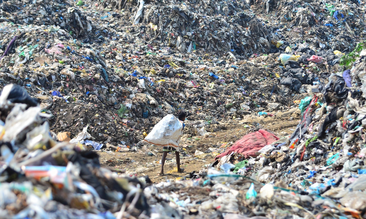 A rag picker returns with reusable items after collecting from a waste dumping site on the eve of World Environment Day in Dimapur, India on June 4, 2023. World Environment Day, a United Nations initiative, is marked annually on June 5, with this year's theme as 