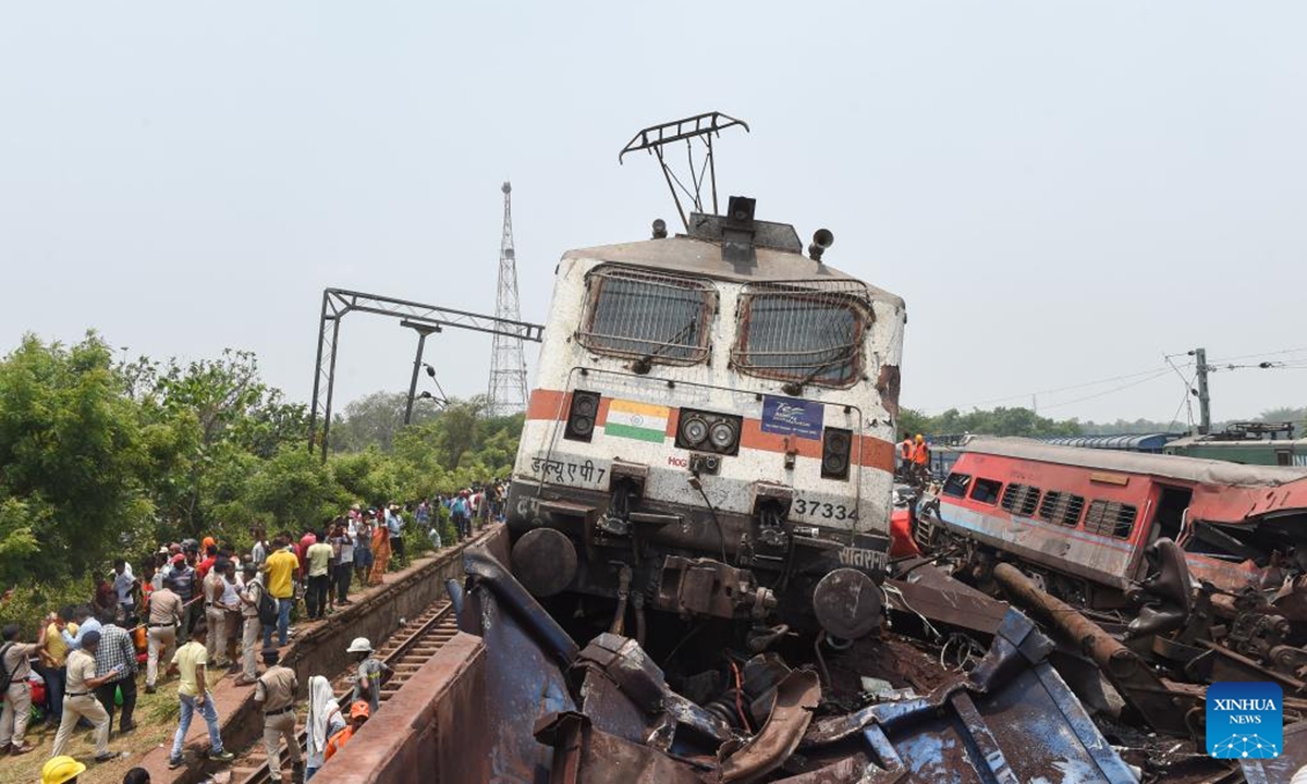 People gather at the site of a train collision in Balasore district in the eastern Indian state of Odisha, June 3, 2023.(Xinhua/Javed Dar)