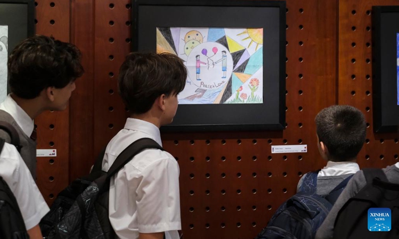 Students view an award-winning artwork at an awards ceremony for the 14th Imagining China children's art competition in Valletta, Malta, on June 6, 2023. An exhibition showcasing the tea culture of Xi'an, Shaanxi Province in northwest China, commenced on Tuesday at the China Cultural Centre in Malta.(Photo: Xinhua)