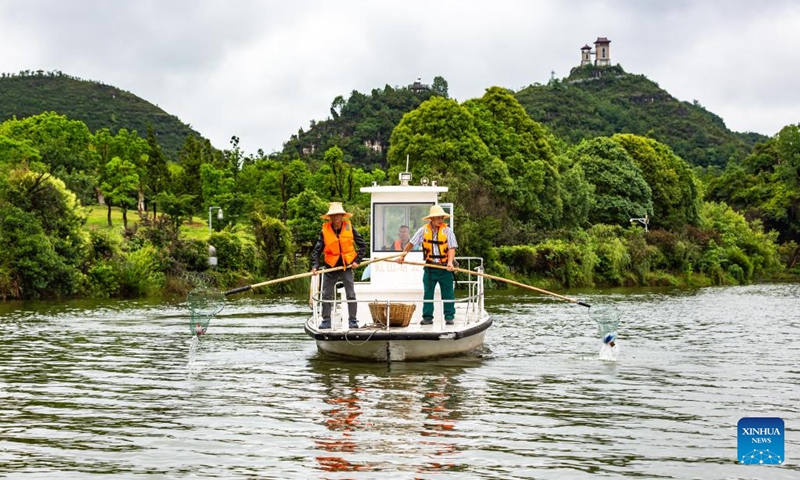 Workers clean the Hongshan Lake in Xixiu District of Anshun City, southwest China's Guizhou Province, on June 5, 2023. The World Environment Day 2023 falls on June 5, focusing on combating plastic pollution. People across China took action to protect the ecological environment in the county.(Photo: Xinhua)