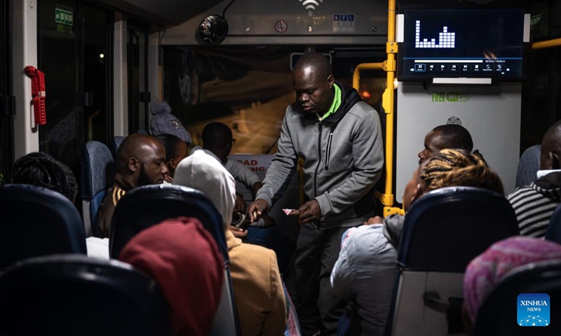 A conductor from BasiGo collects fare on an electric bus in Nairobi, Kenya, on June 3, 2023. The World Environment Day falls on June 5. In order to cope with climate change and protect the ecological environment, Kenya has made great efforts to promote the operation of electric buses and has introduced relevant policies to promote emission reduction.(Photo: Xinhua)