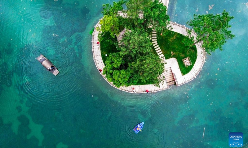 This aerial photo taken on June 5, 2023 shows volunteers cleaning the river at Changgang Village of Heping Town, Huzhou City, east China's Zhejiang Province. The World Environment Day 2023 falls on June 5, focusing on combating plastic pollution. People across China took action to protect the ecological environment in the county.(Photo: Xinhua)