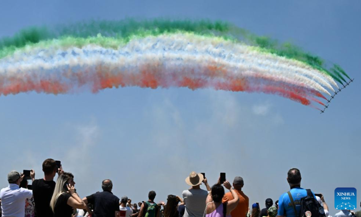 People watch the performance of the Italian Frecce Tricolori aerobatic squad during a media preview of an airshow celebrating the centenary of the Italian Air Force in Pratica di Mare airbase, Italy, on June 16, 2023. Photo:Xinhua