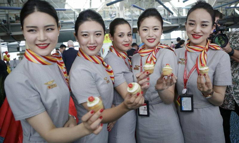 Flight attendants of China's Hainan Airlines pose for photos after they arrived at Vancouver International Airport in Vancouver, Canada, May 25, 2018. File Photo: Xinhua