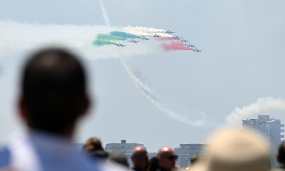 People watch the performance of the Italian Frecce Tricolori aerobatic squad during a media preview of an airshow celebrating the centenary of the Italian Air Force in Pratica di Mare airbase, Italy, on June 16, 2023. Photo:Xinhua