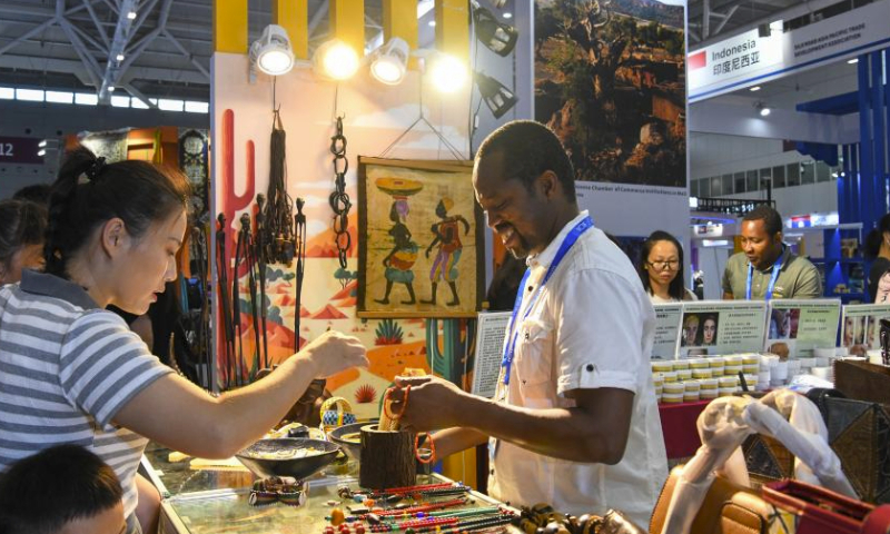 Visitors buy products at a booth from Mali during the 19th China (Shenzhen) International Cultural Industries Fair in Shenzhen, south China's Guangdong Province, June 9, 2023. The 19th China (Shenzhen) International Cultural Industries Fair kicked off here on Wednesday, which is expected to inject new impetus into the development of the country's cultural industry. Over 300 exhibitors from more than 50 countries and regions have registered to display their distinctive products in the fair's Belt and Road International Exhibition Area. (Xinhua/Liang Xu)