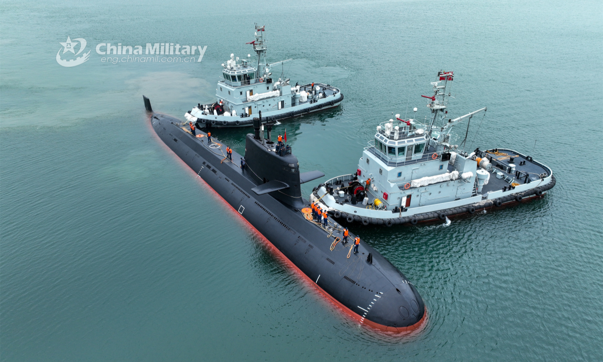 Two towboats attached to a naval submarine flotilla under the PLA Northern Theater Command tow a submarine to bear off a port during a training exercise recently in waters of the Yellow Sea. Photo: China Military