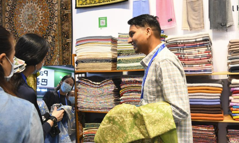 Visitors buy products at a booth from Nepal during the 19th China (Shenzhen) International Cultural Industries Fair in Shenzhen, south China's Guangdong Province, June 9, 2023. The 19th China (Shenzhen) International Cultural Industries Fair kicked off here on Wednesday, which is expected to inject new impetus into the development of the country's cultural industry. Over 300 exhibitors from more than 50 countries and regions have registered to display their distinctive products in the fair's Belt and Road International Exhibition Area. (Xinhua/Liang Xu)