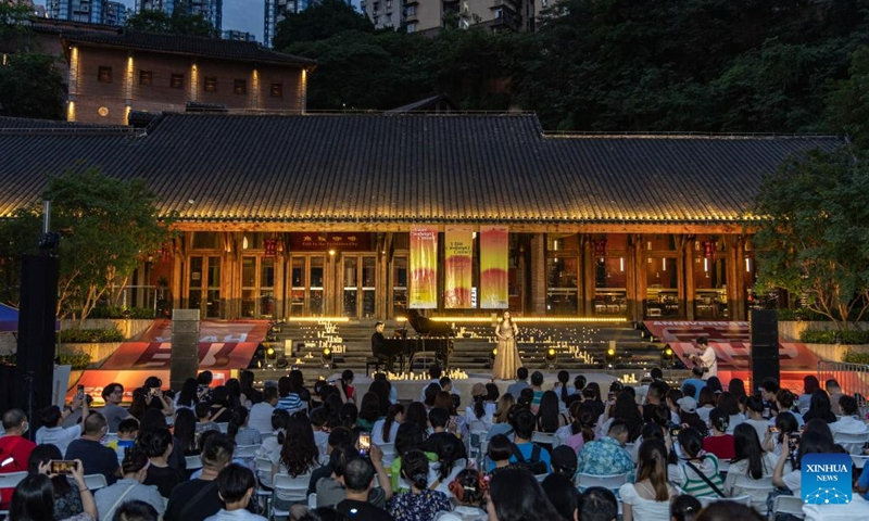 People enjoy a concert in celebration of the second anniversary of the opening of a museum displaying the history of Palace Museum antiques moved there during World War II in southwest China's Chongqing, June 10, 2023. The museum is located in a former foreign firm, where nearly 4,000 cases of antiques were stored during wartime.(Photo: Xinhua)